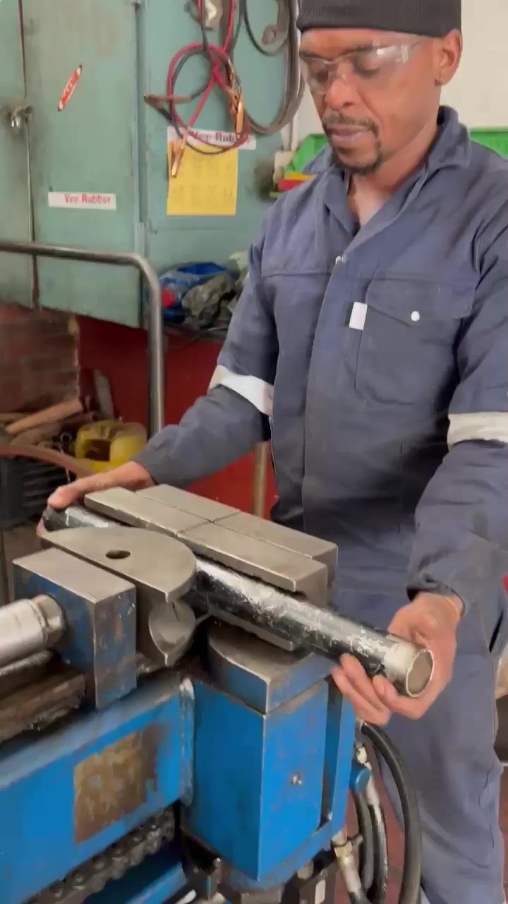 Crew member at the pipe-bending machine